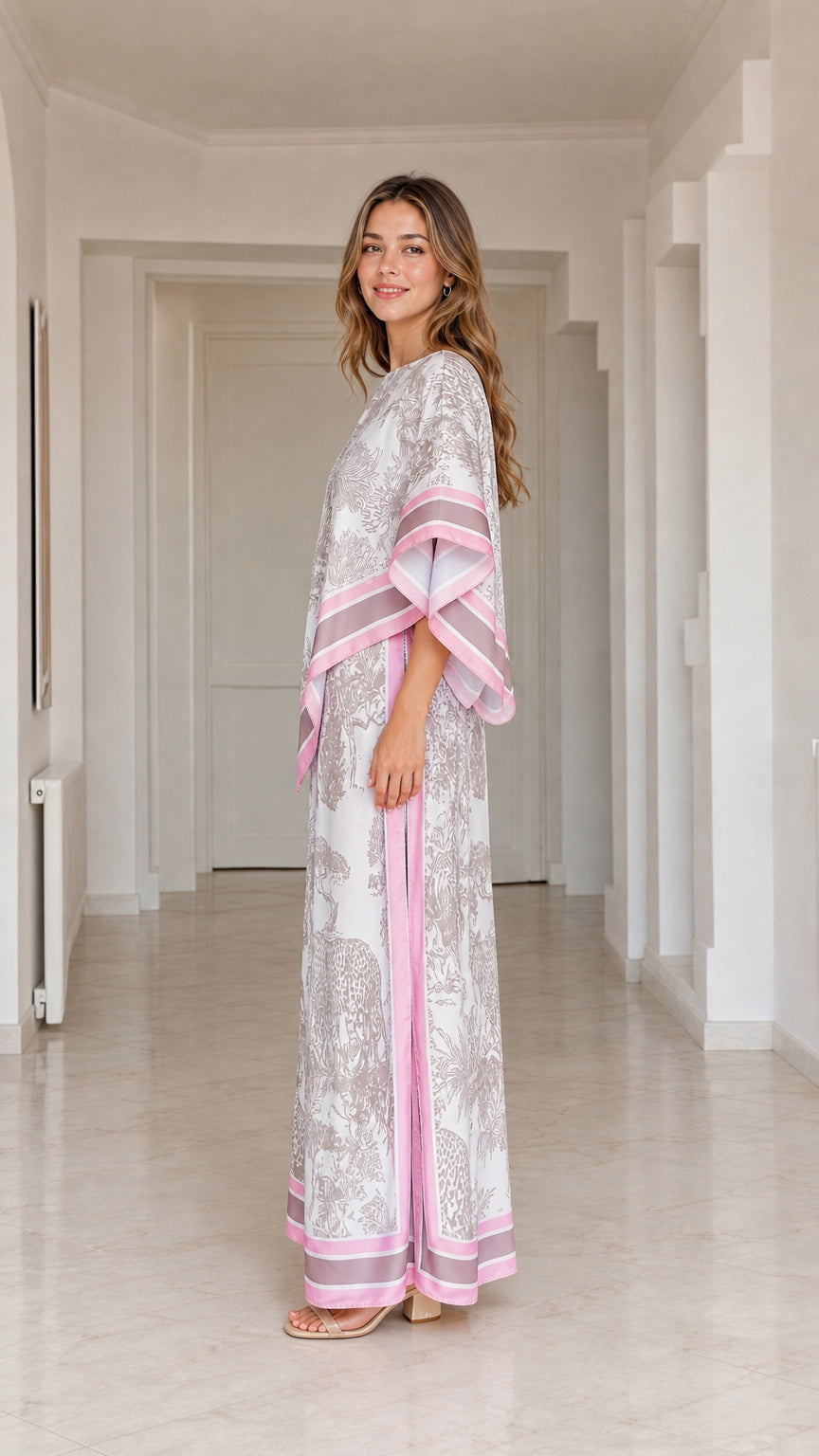 Side profile view of model wearing draped white animal print two-piece resort pant set