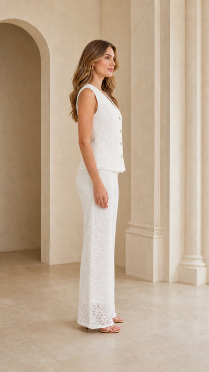 Side profile view of model wearing white floral lace two-piece trouser set
