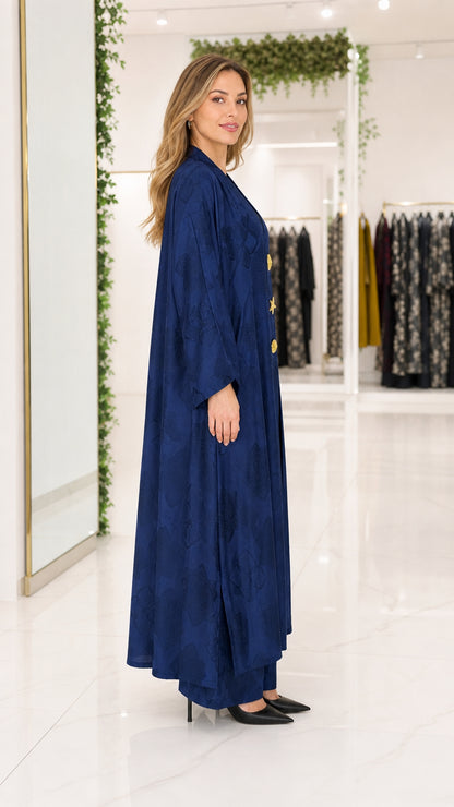 Side profile of woman in navy blue flowing jacquard abaya