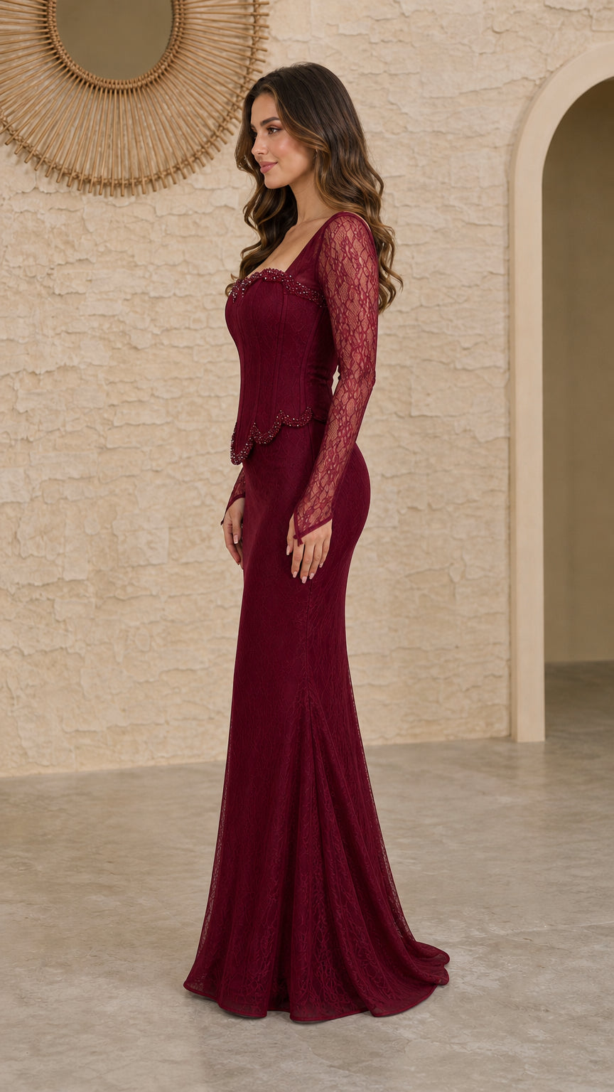 Side profile view of burgundy mermaid lace gown with sheer long sleeves