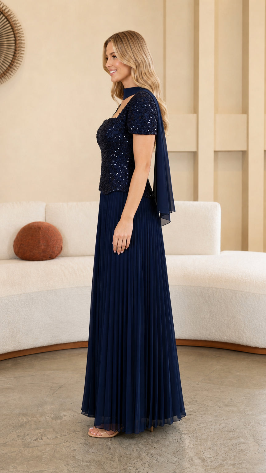 Model wearing Navy Blue formal pleated maxi gown side profile view