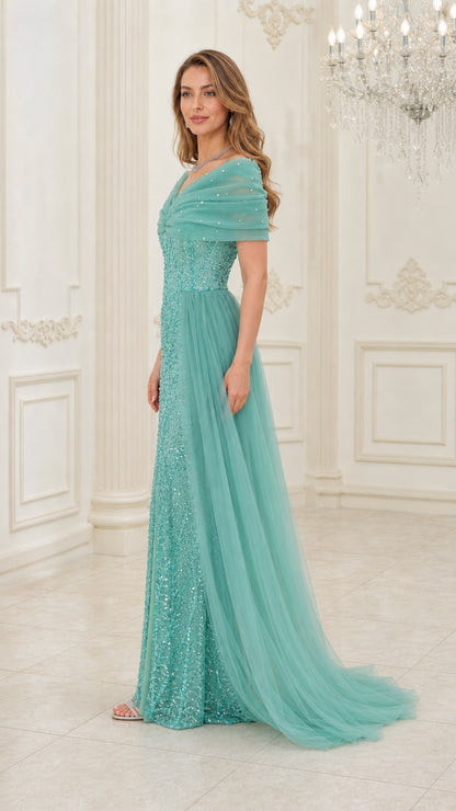 Side angle view of aqua green sequin floor-length formal dress