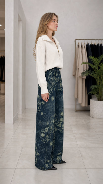 Side profile of woman modeling Denim Blue floral embroidered wide leg trousers
