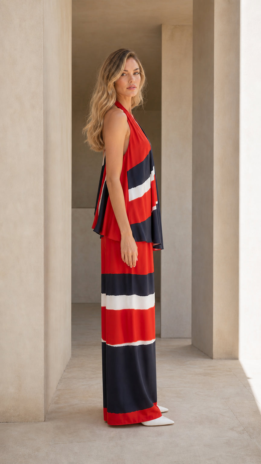 Side profile view of flowy red color block halter top and matching wide-leg trousers
