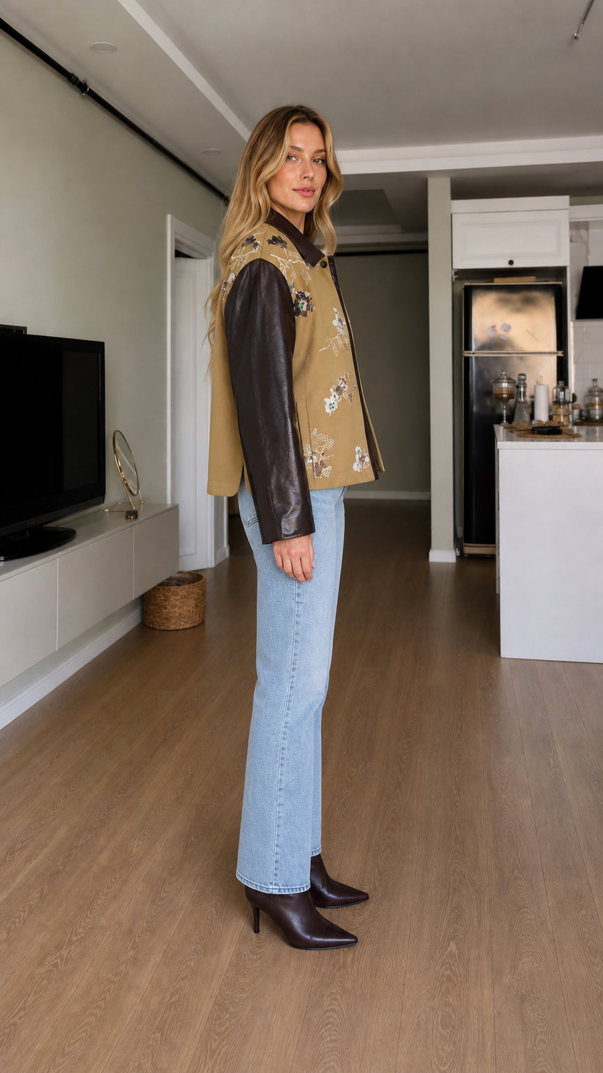 Side profile view of model wearing camel embroidered contrast sleeve jacket