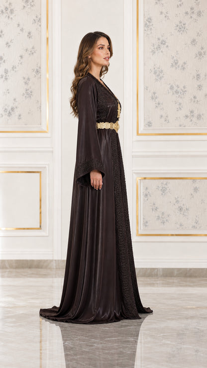 Side profile view of woman wearing chocolate brown embroidered satin kaftan gown
