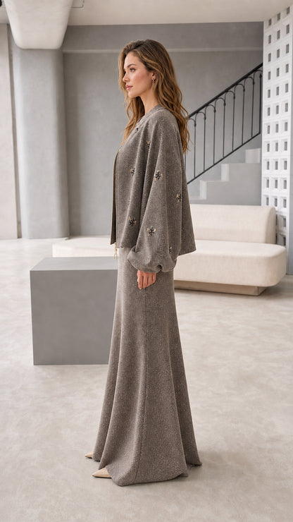 Side view of women's taupe embroidered zip jacket and maxi skirt set