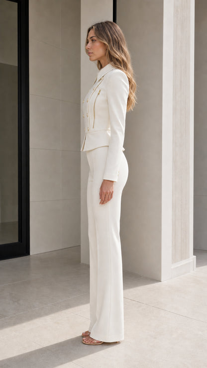 Side profile of model in fitted white suit set featuring flare leg trousers