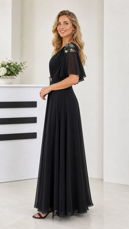 Side angle view of model wearing black long chiffon dress with ruched bodice