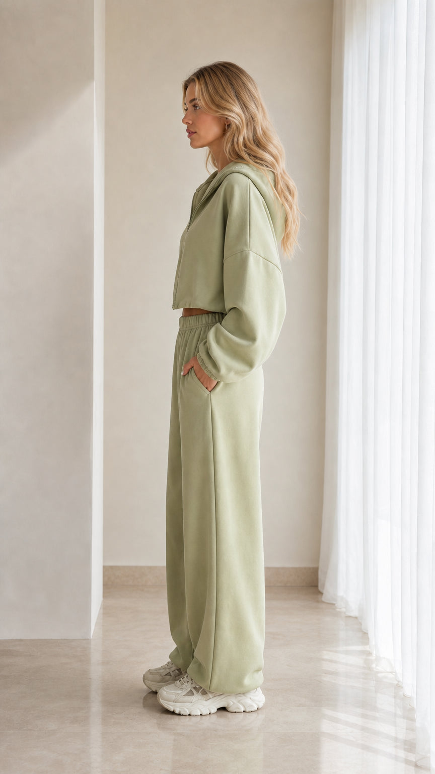 Side profile of model in sage green matching tracksuit set