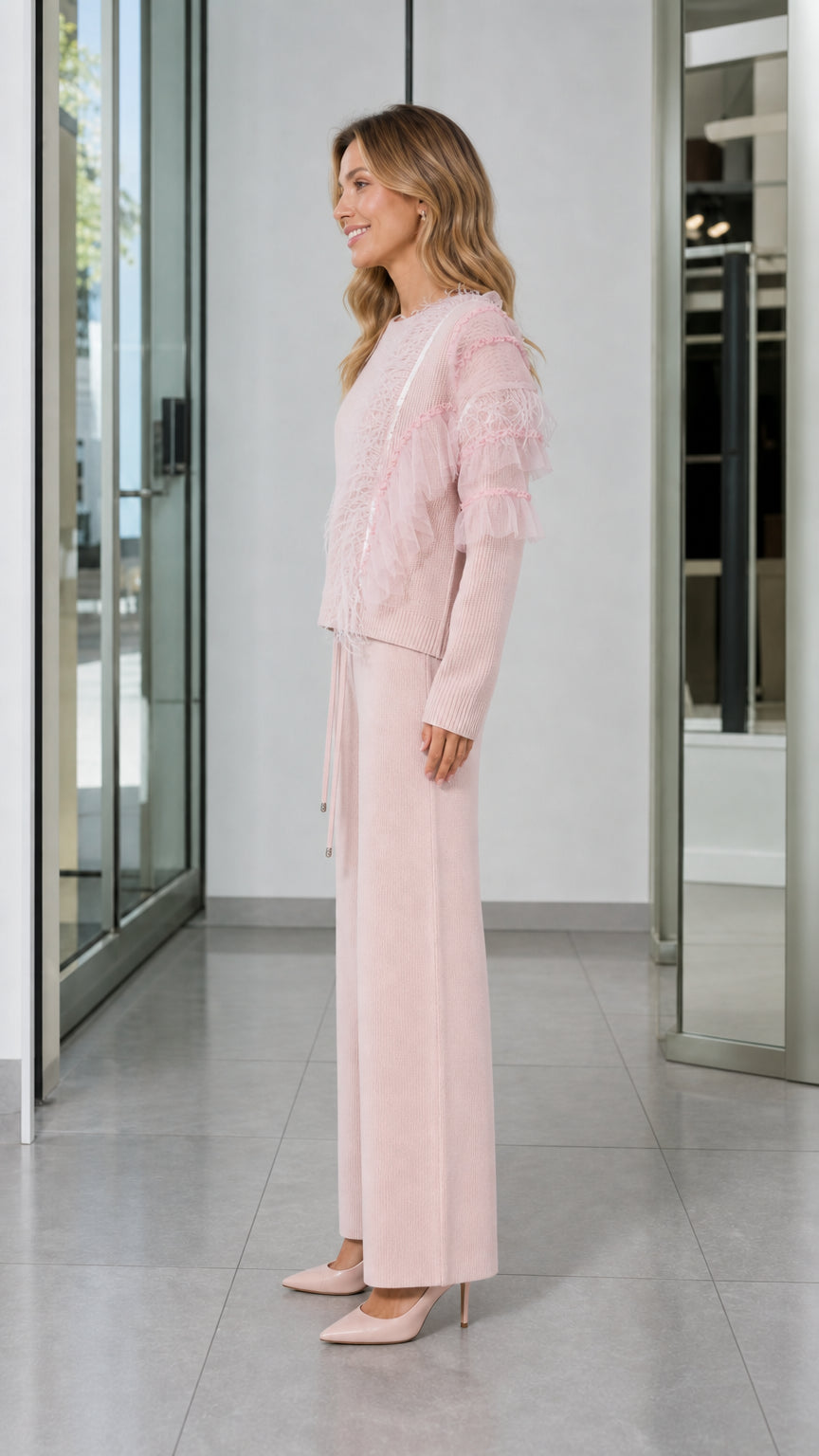Side view of woman in Light Pink two-piece knit sweater and wide-leg trouser set