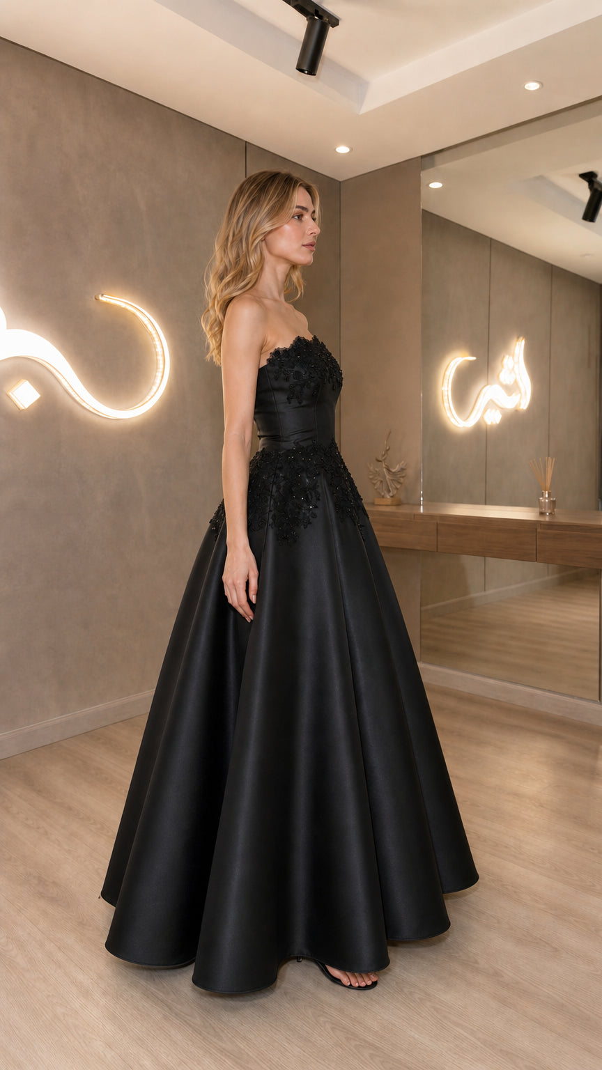 Side view of black strapless satin formal dress
