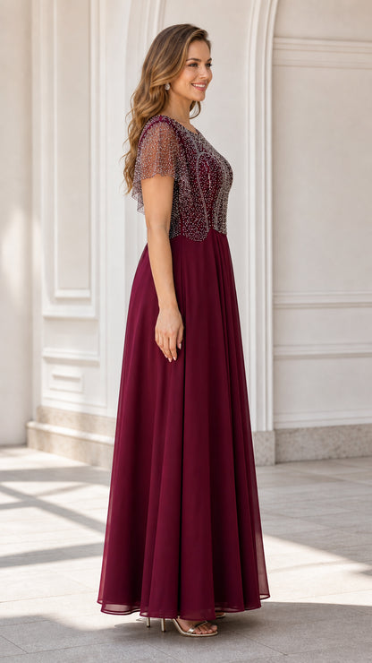 Side angle view of model wearing burgundy formal evening maxi dress