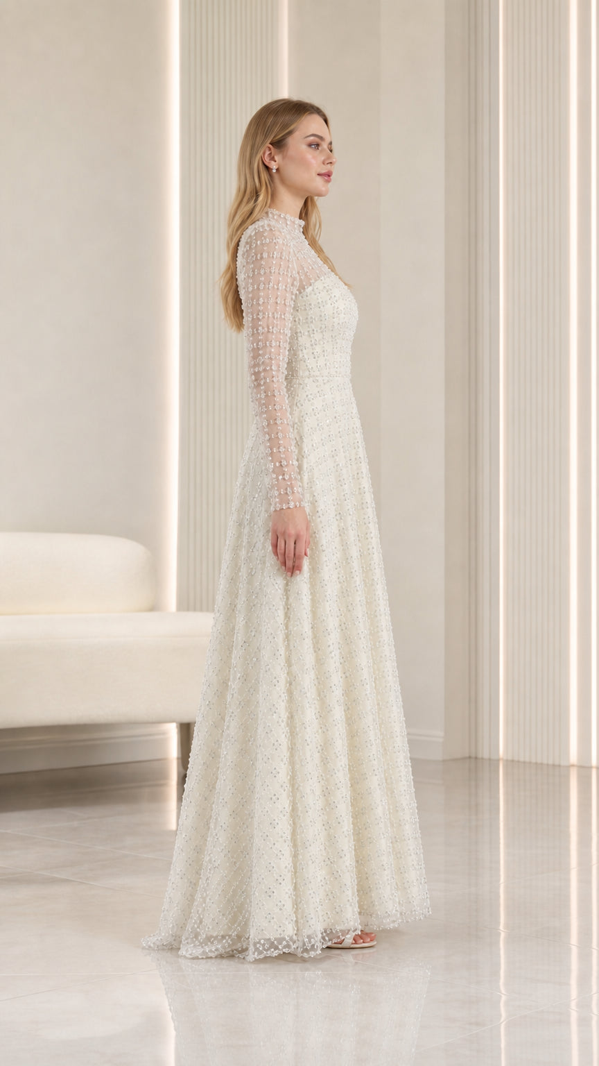 Side profile view of ivory long sleeve embellished A-line evening dress