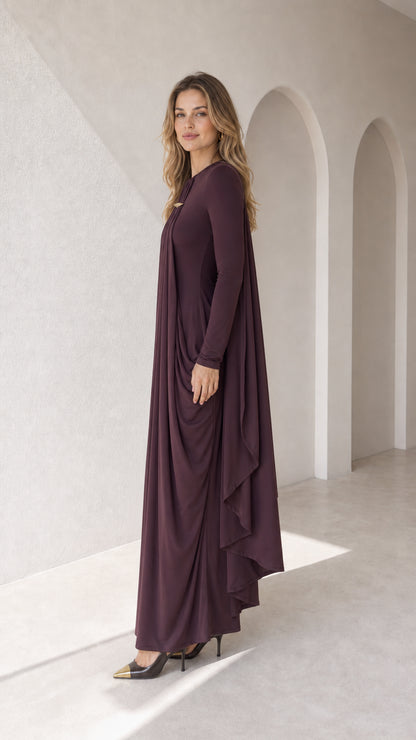 Side angle view of plum long sleeve pleated cape gown showing flowing drape