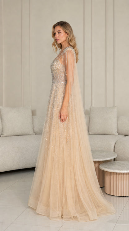 Side profile of champagne tulle formal dress with beaded shoulder cape