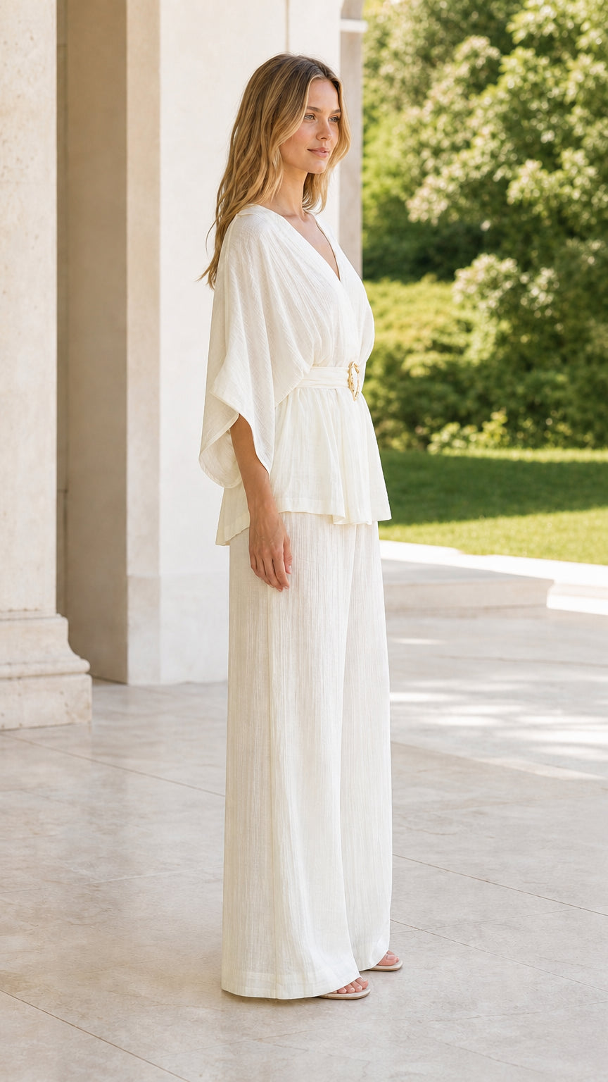 Side view of model in ivory kimono sleeve belted top and matching palazzo pants
