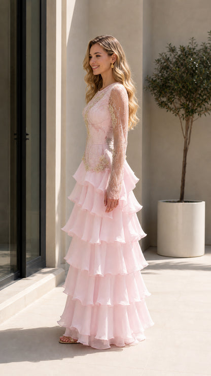 Side angle of Blush Pink embroidered long sleeve gown showing tiered ruffle skirt