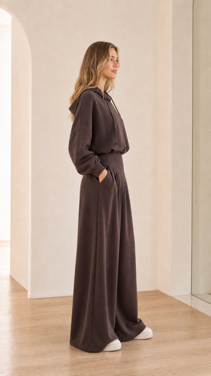 Side angle of chocolate brown pleated wide-leg trousers and hoodie set