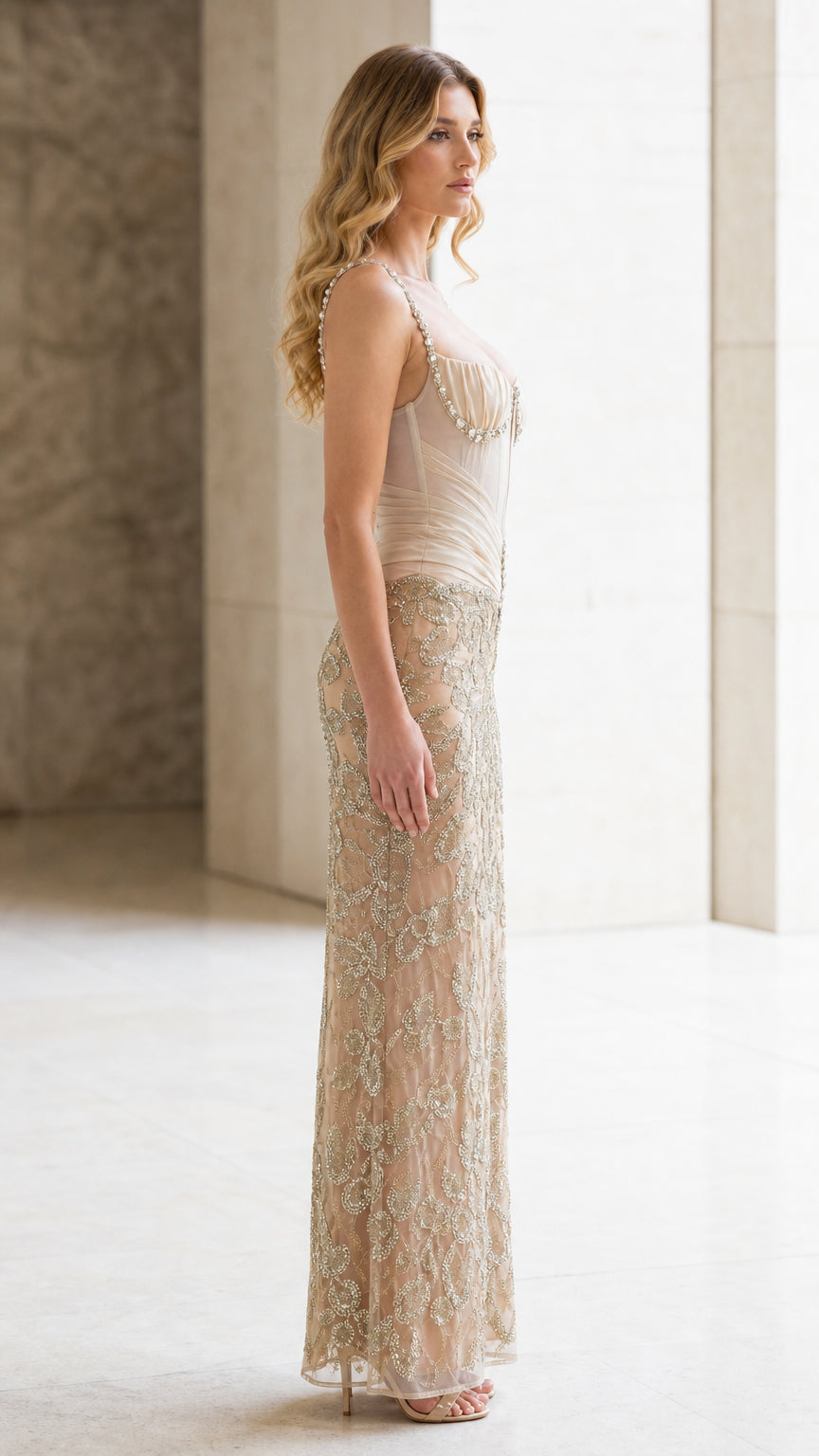Side profile of champagne sheer corset embellished formal dress
