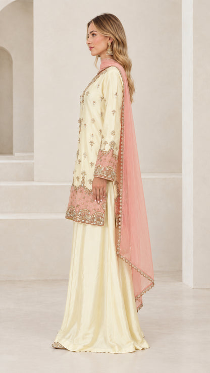 Side profile of women's cream embroidered tunic with flared pants and dupatta