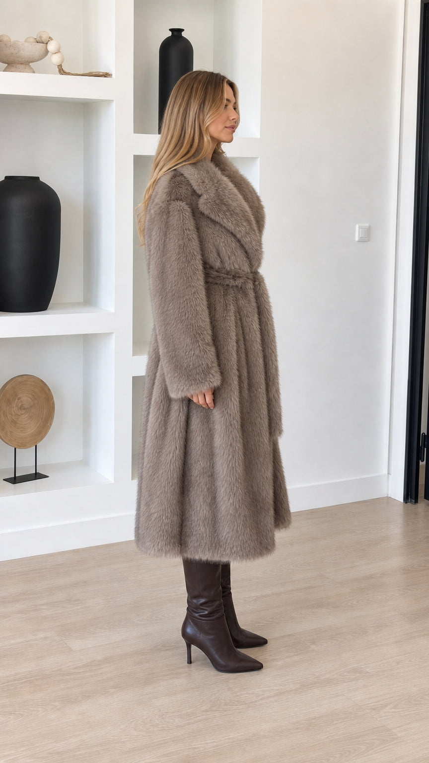 Side profile view of taupe longline faux fur coat showing relaxed drape and midi length