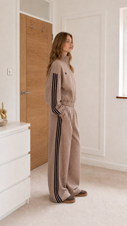 Taupe gingham jumpsuit shown from the side with wide-leg fit and striped sleeves
