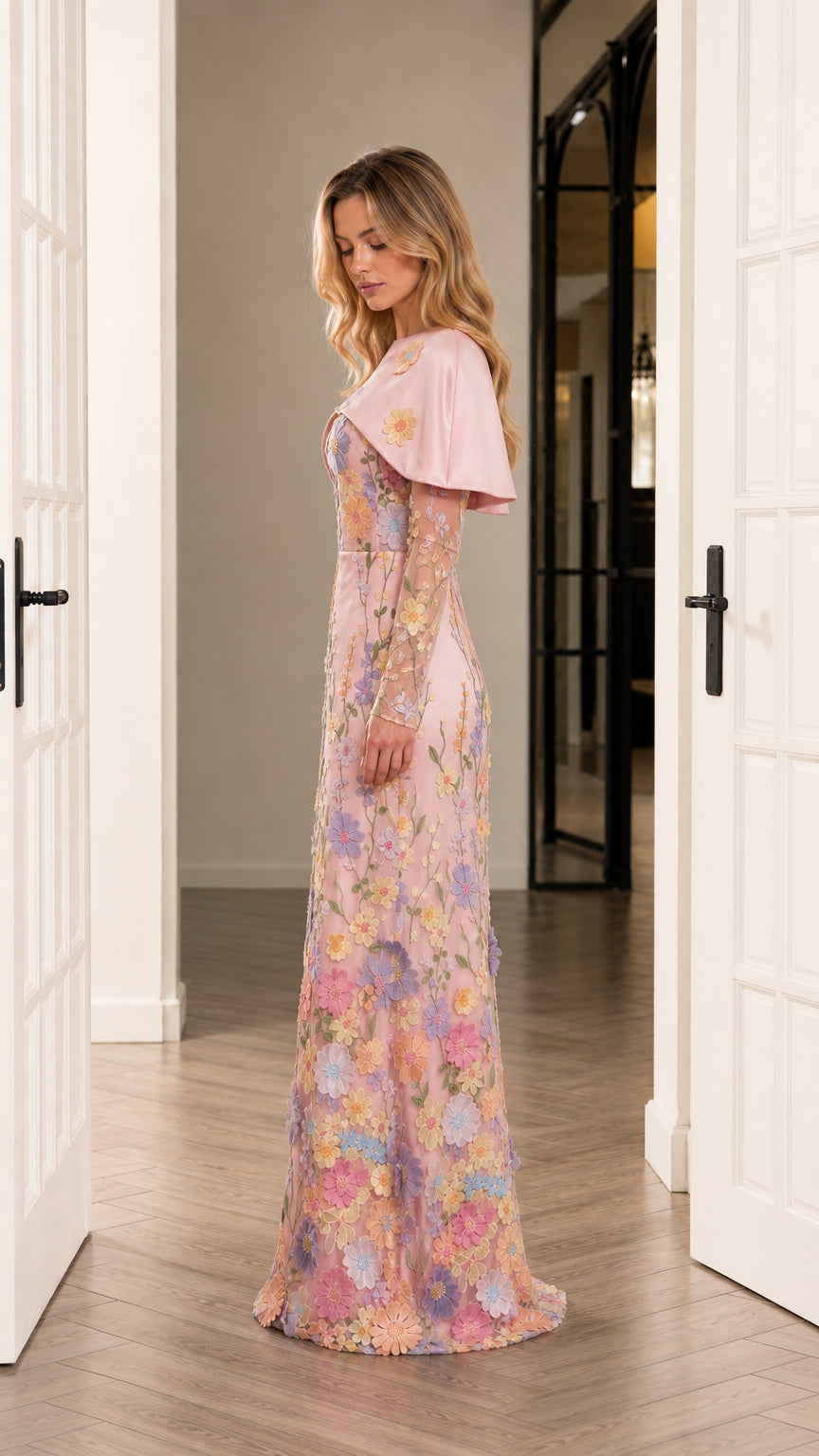 Side profile of blush pink long sleeve floral embroidered formal maxi gown with capelet
