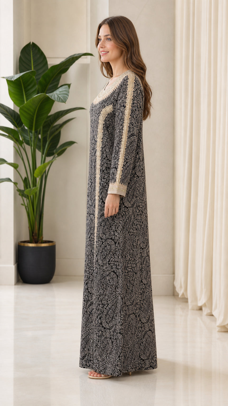 Side profile view of model wearing black modest long sleeve maxi gown