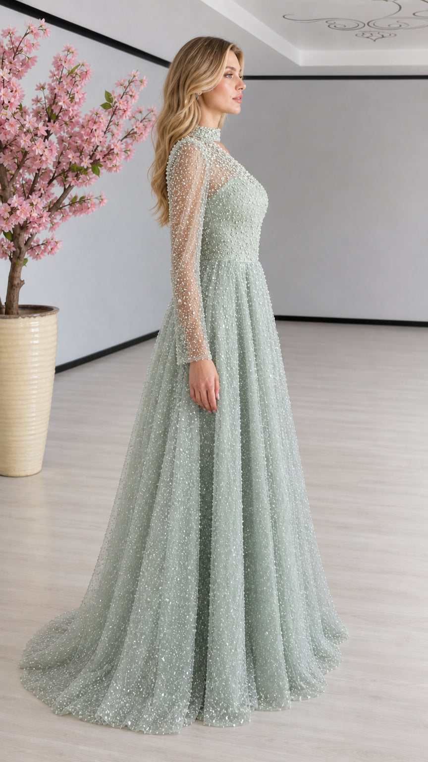 Side profile view of sage green beaded illusion sleeve formal gown
