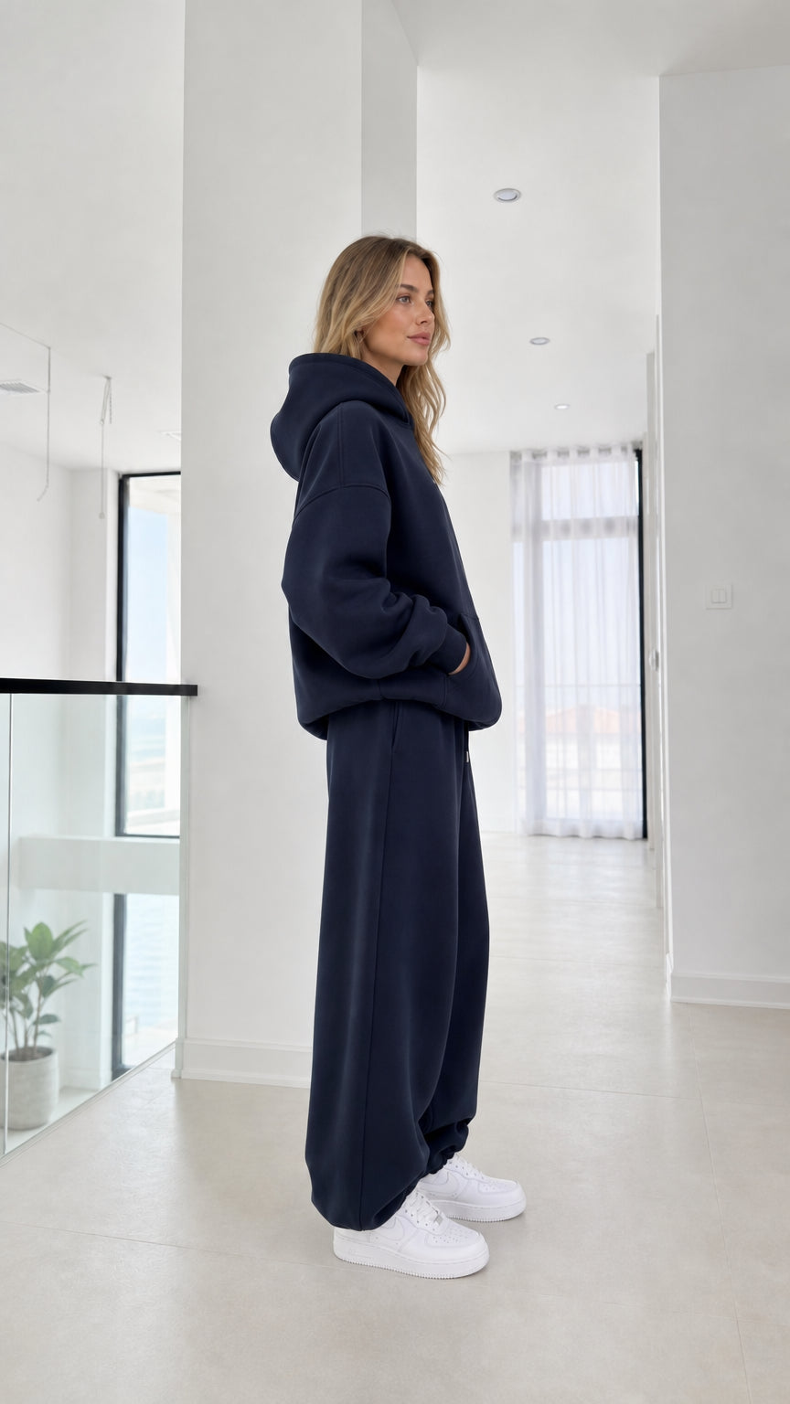 Side full-length view of model wearing the navy blue 2-piece sweatsuit