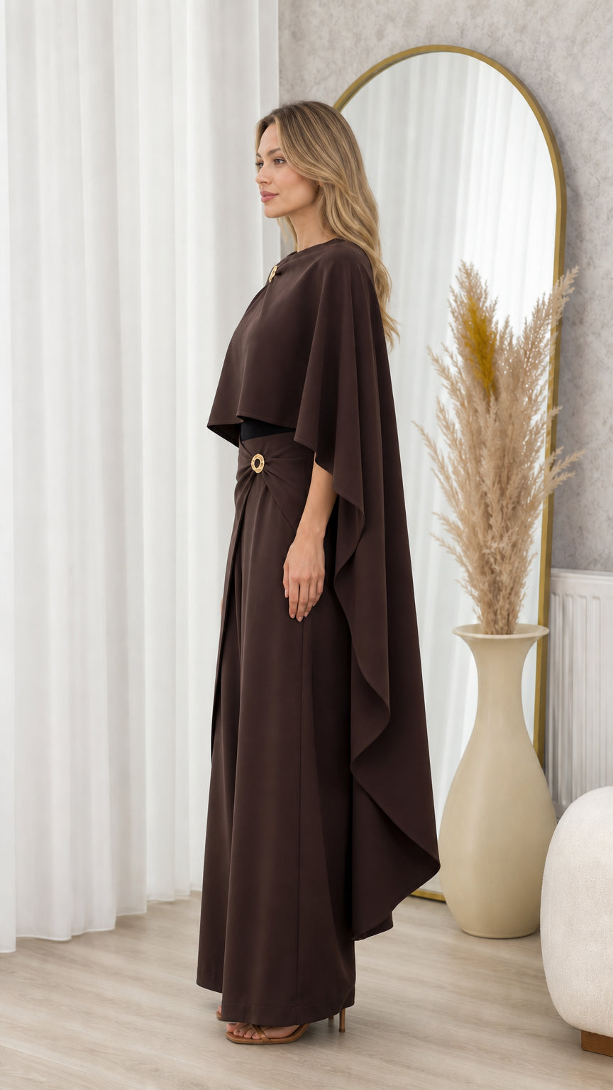 Side profile view of chocolate brown capelet top and wide-leg pant set showing elegant drape