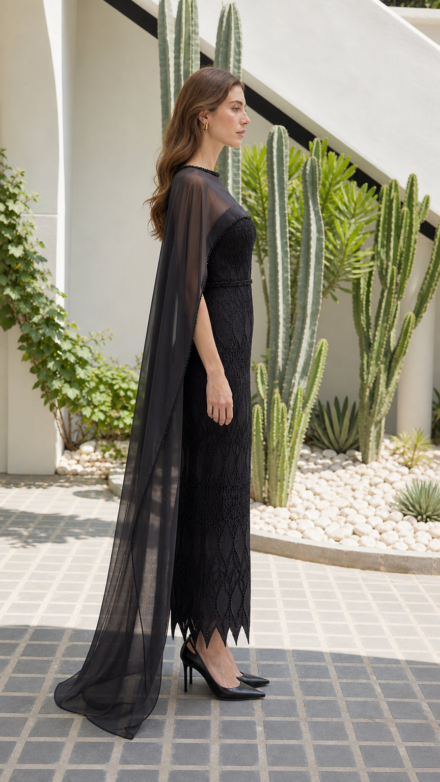 Side profile of black lace formal dress showing dramatic cape train