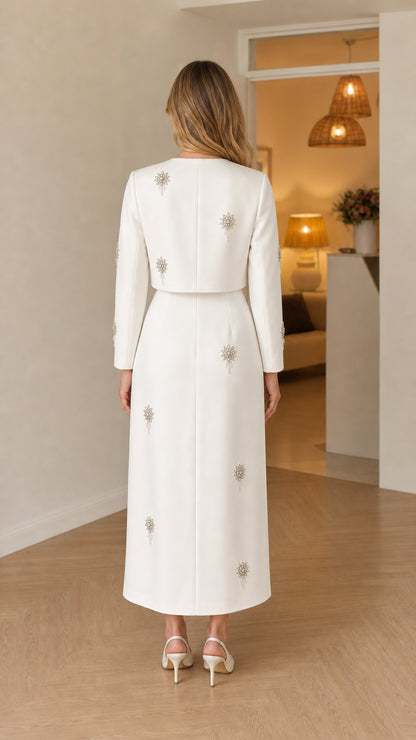 Back view of woman wearing white long sleeve maxi dress with crystal accents