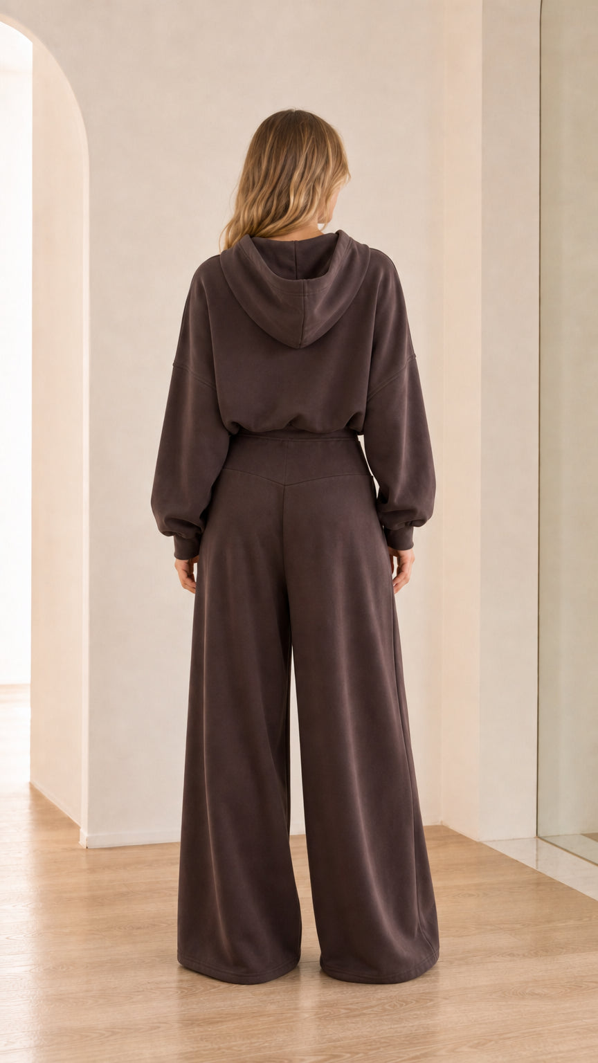 Back view of model wearing chocolate brown hoodie and wide-leg sweatpants set