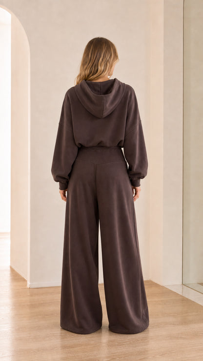 Back view of model wearing chocolate brown hoodie and wide-leg sweatpants set