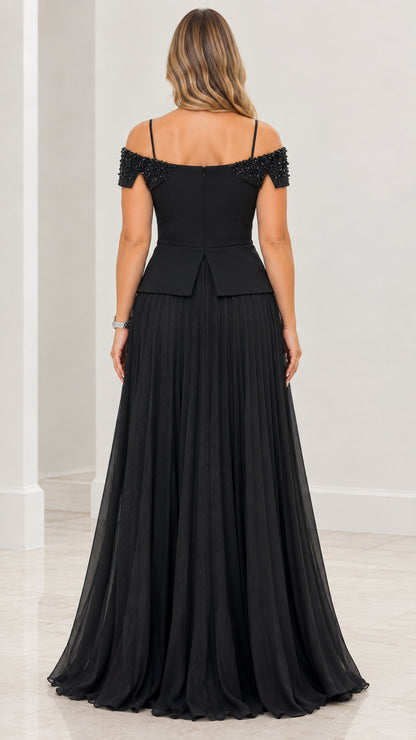 Back view of black cold-shoulder evening gown with pleated skirt