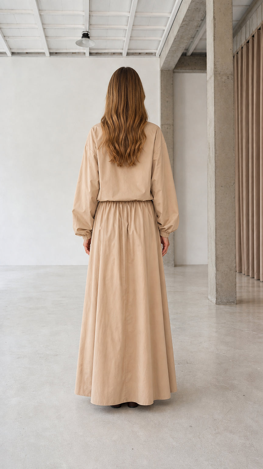 Back view of woman wearing beige modest long sleeve maxi dress