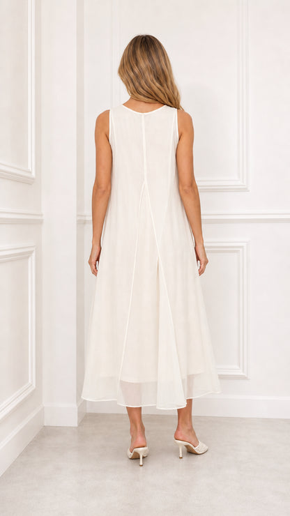 Back view of model in ivory flowy chiffon tiered midi dress