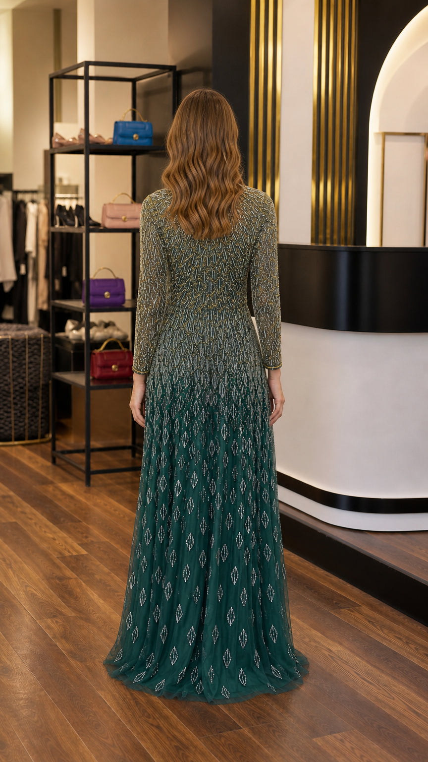 Back view of emerald green long sleeve beaded evening gown
