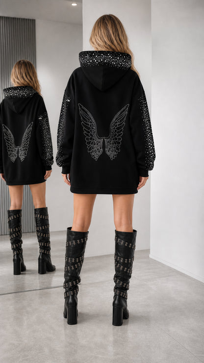 Back view of model showing large rhinestone angel wing motif on black hoodie dress