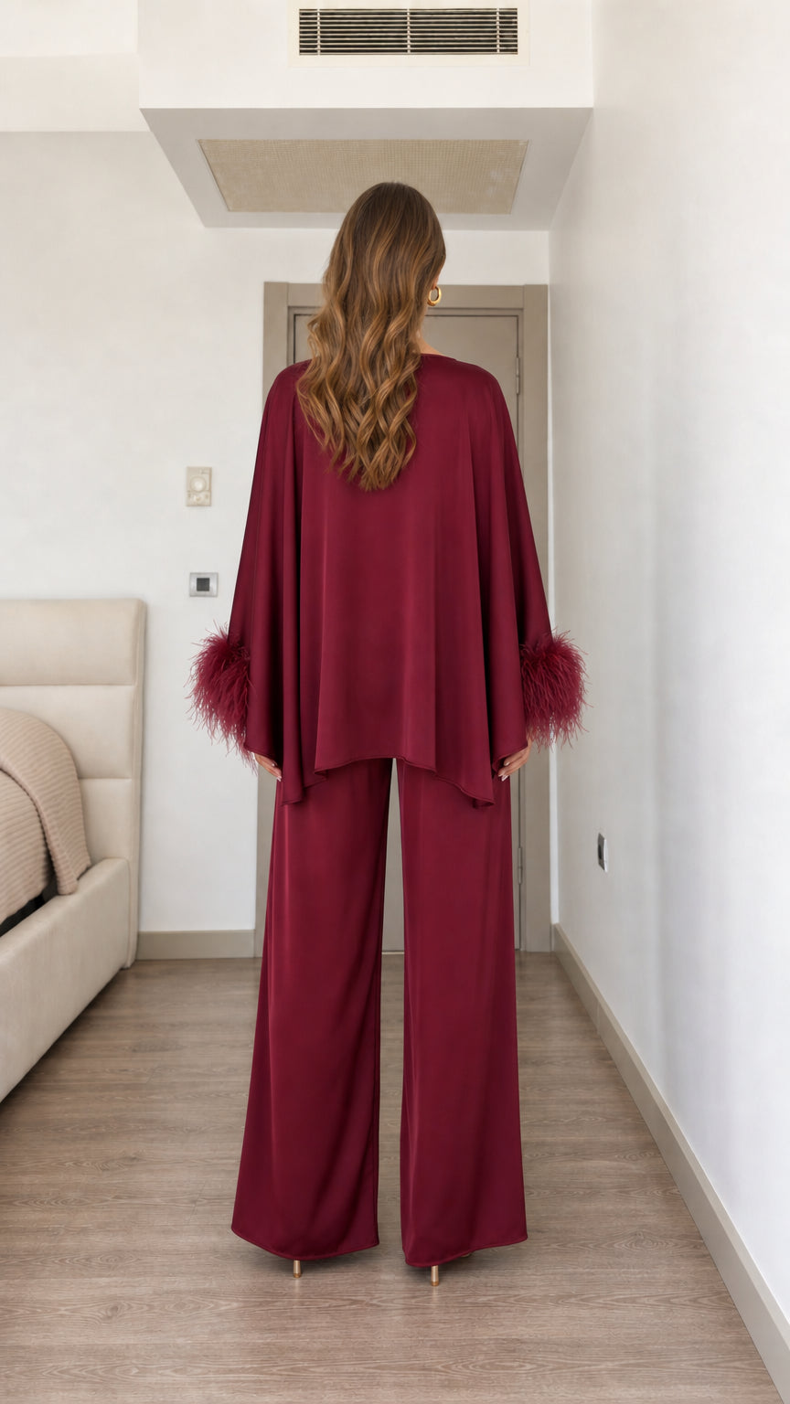 Back view of woman wearing burgundy satin two-piece set