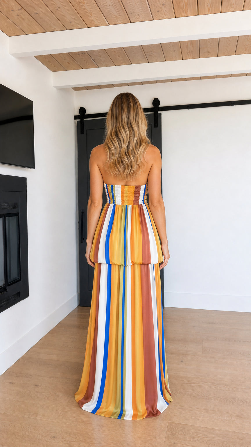 Back view of model showing smocked bodice on Mustard Multi striped maxi dress