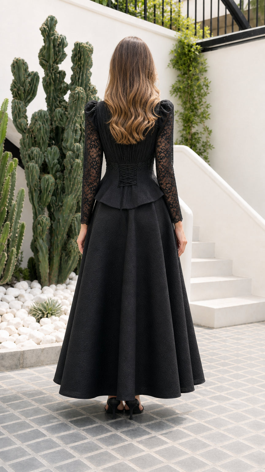 Back view of black formal maxi dress showing corset lace-up tie detail
