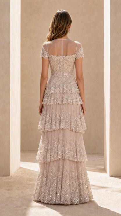 Back view of champagne embroidered tiered floor-length formal gown