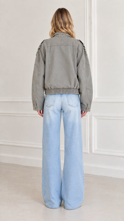 Back view of model showing gathered elastic hem of Sage Green utility jacket