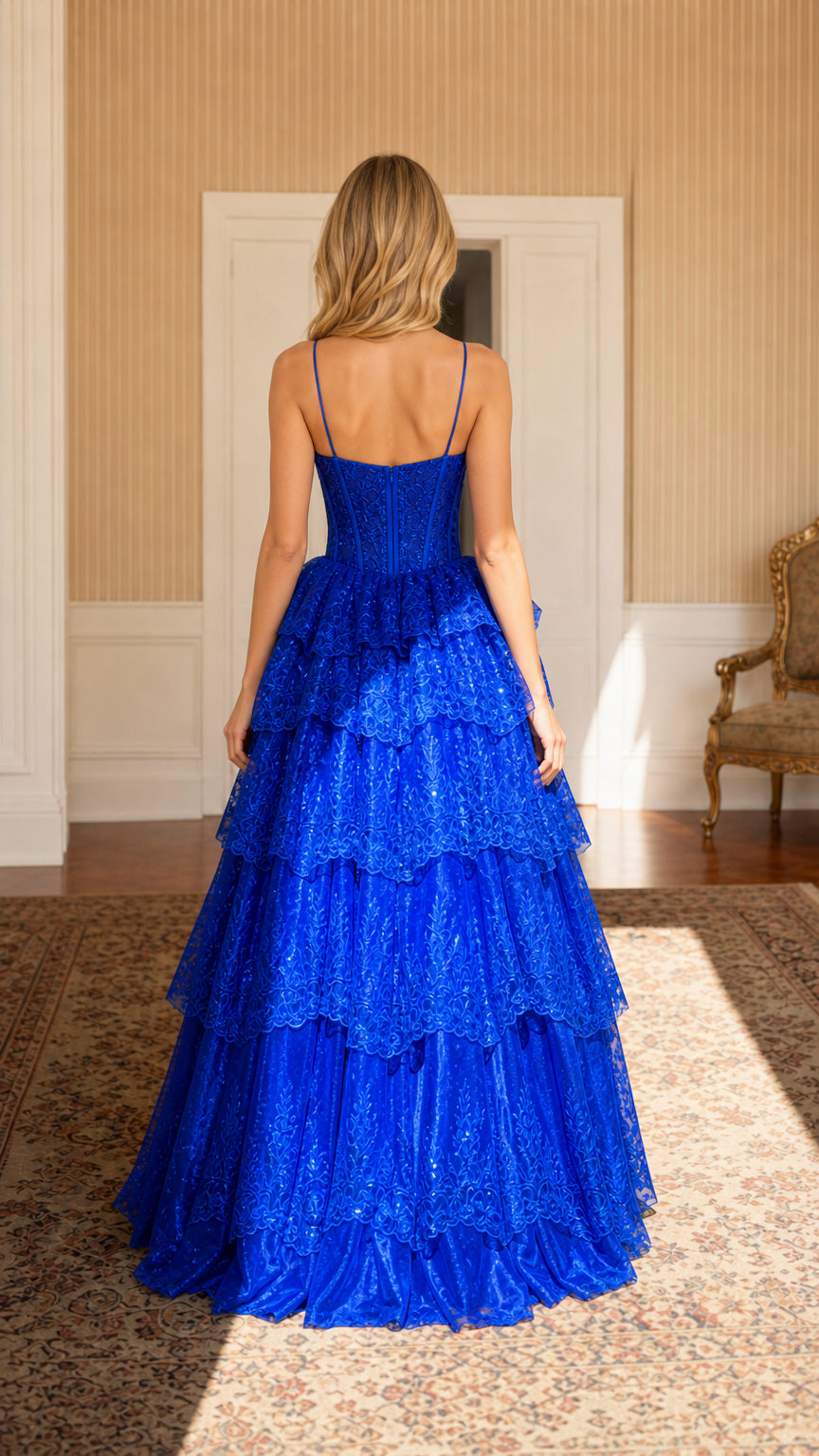 Back view of model wearing Royal Blue spaghetti strap tiered lace ball gown