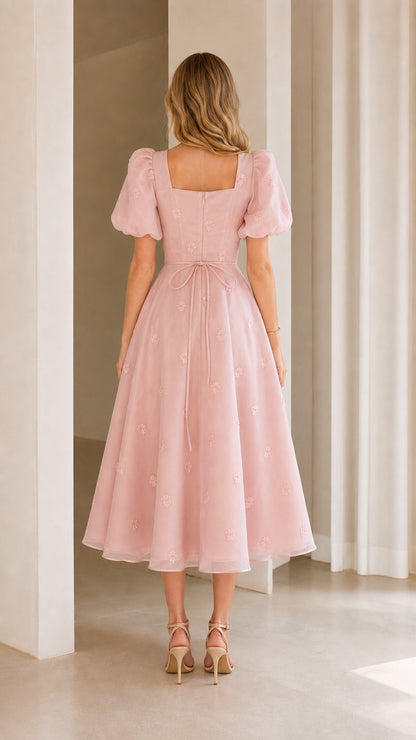 Back view of blush pink midi dress showing back square neck and tie sash
