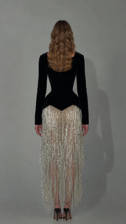Back view of black velvet corset bodice with fitted long sleeves and fringe skirt