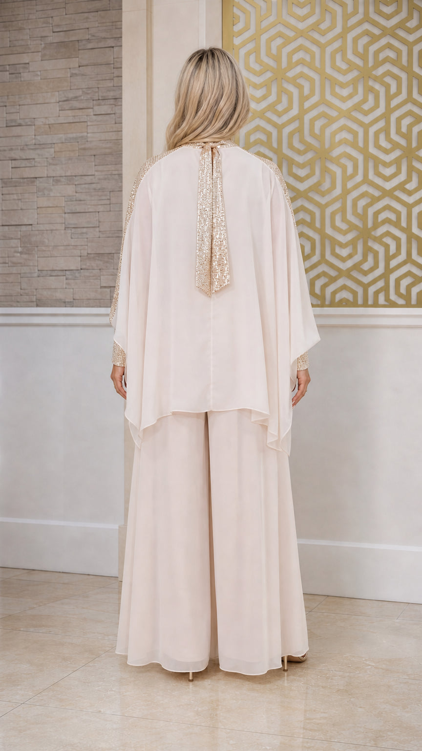 Back view of champagne formal chiffon cape top and wide leg pants
